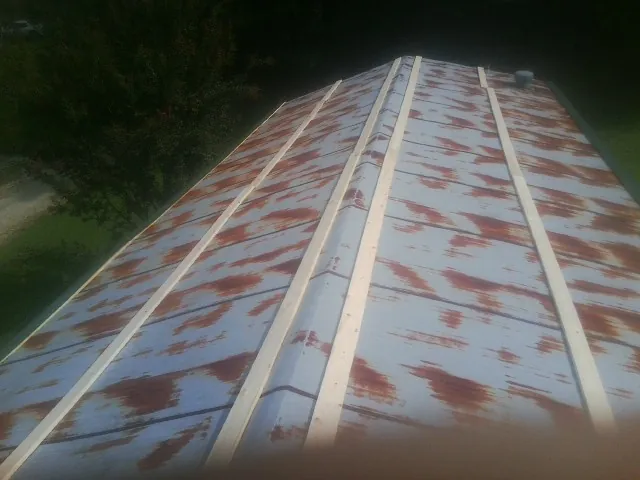 Rusted metal roof panels with new wood purlins before replacement — Storm Damage Roof Repair in Labadie by Roofing Brothers